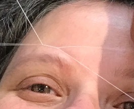 image of a piece of thread criss-crossing to remove facial hair.